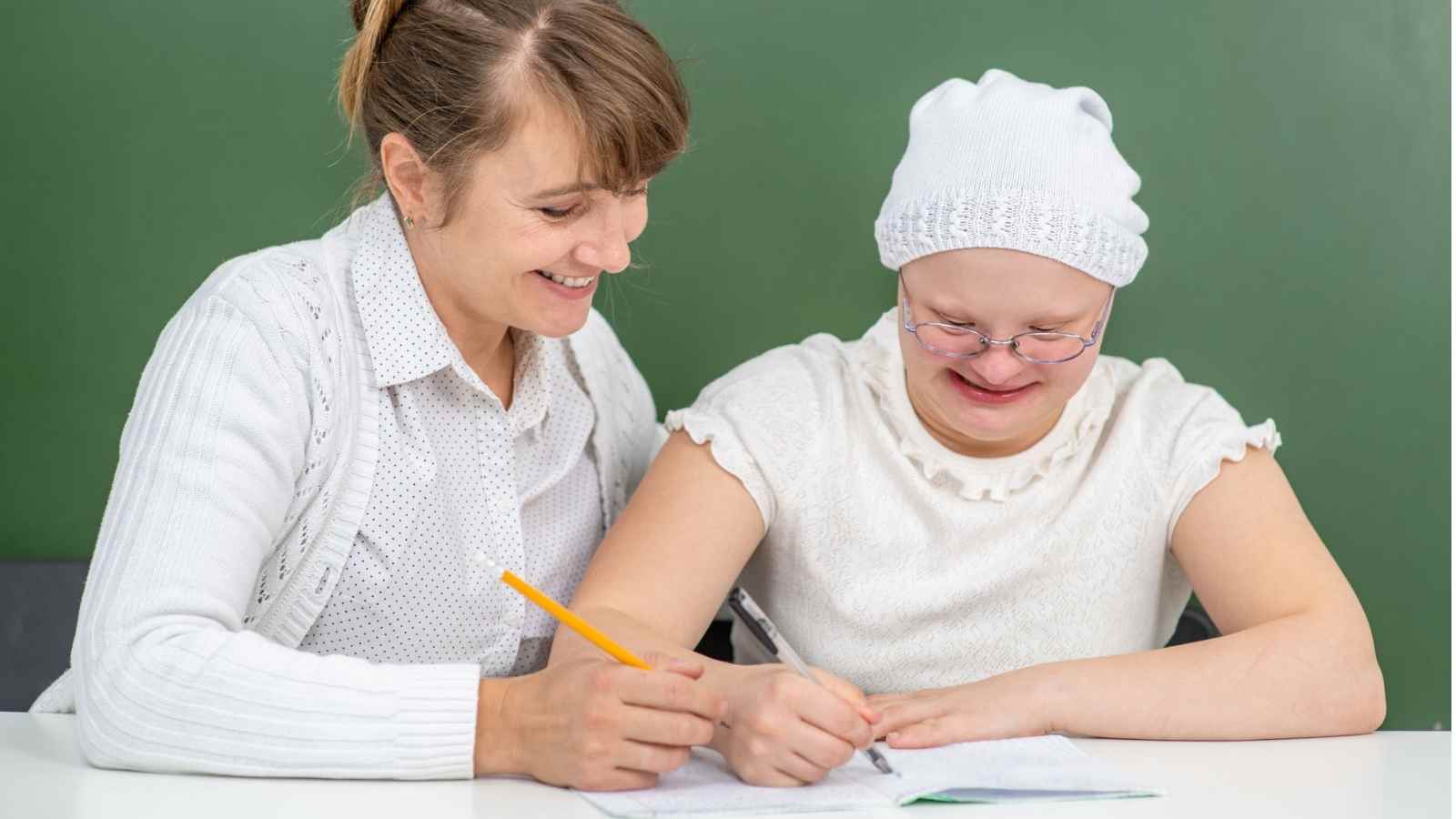 Female teacher working with special needs student