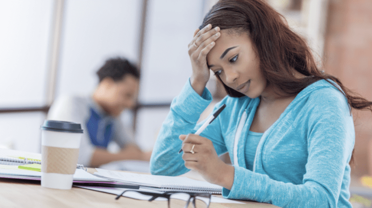 Student writing notes in notebook