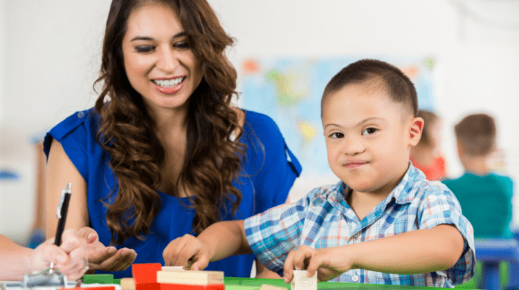 Special Education Teacher working with down syndrom child