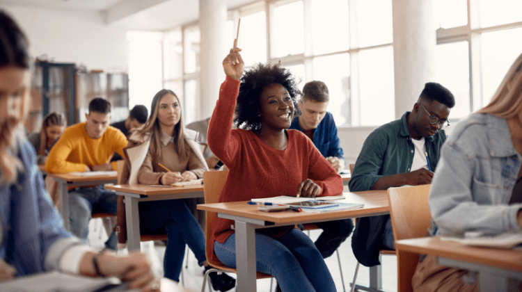 Black Student raises her hand in college class