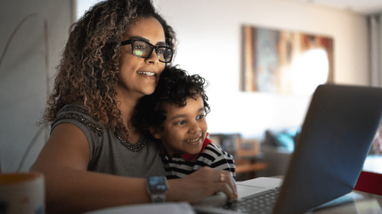 single mom studying on laptop with child